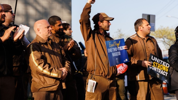 UPS workers and Teamsters members during a rally outside a UPS hub in the Brooklyn borough of New York, US, on Friday, April 21, 2023. Part-timers and weekend drivers are expected to be among the key points of debate as the Teamsters and United Parcel Service Inc. begin talks this week on the largest collective bargaining agreement in the US, reports the Wall Street Journal.