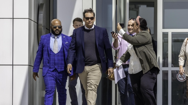Representative George Santos, a Republican from New York, center, departs federal court in Central Islip, New York, US, on Wednesday, May 5, 2023. Santos was arrested and charged by US prosecutors with fraud and money laundering, as the embattled Republican congressman from New York comes under increasing pressure to resign.