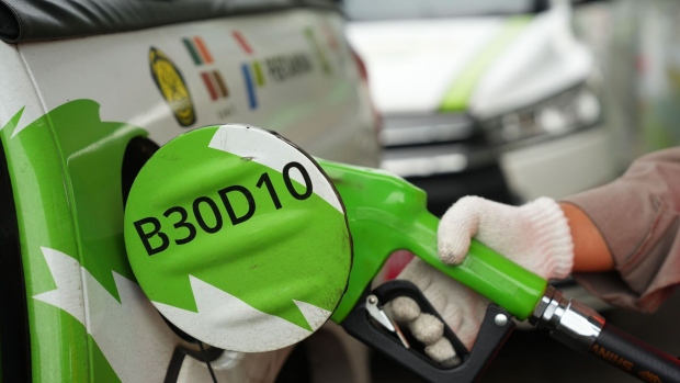 A worker refuels a vehicle during a road test of 40% palm-based biodiesel in Cirebon, West Java, Indonesia, on Wednesday, Oct. 26, 2022. Indonesia, the worlds biggestpalm oilproducer, is testing to see whether vehicles can run effectively on diesel blended with 40% cooking oil. A successful outcome would shift more local supply toward biofuel and curb exports. Photographer: Dimas Ardian/Bloomberg