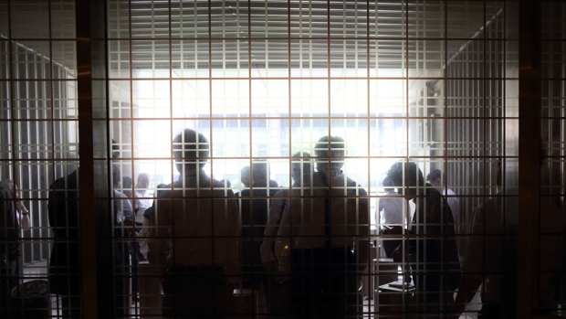 Office workers smoke at a smoking place in a building in Tokyo, Japan, on Tuesday, July 29, 2014.  Photographer: Tomohiro Ohsumi/Bloomberg 