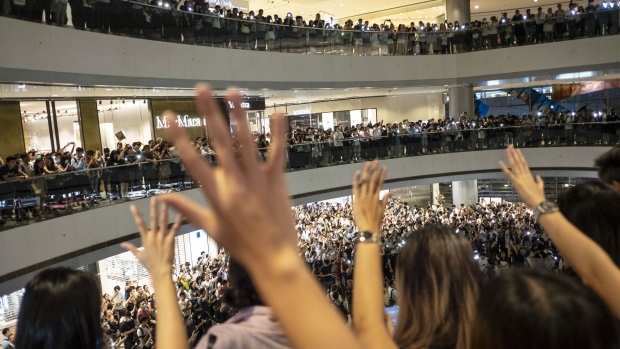 Demonstrators sing the "Glory To Be Thee, Hong Kong" protest song during a flash mob at the International Finance Center (IFC) Mall in Hong Kong, China, on Thursday, Sept. 12, 2019. Hong Kong police banned a planned Sunday march and gathering called by the organizer of some of the citys biggest protests, days after demonstrators set fire to a central subway station as the pro-democracy movement carries on into autumn.
