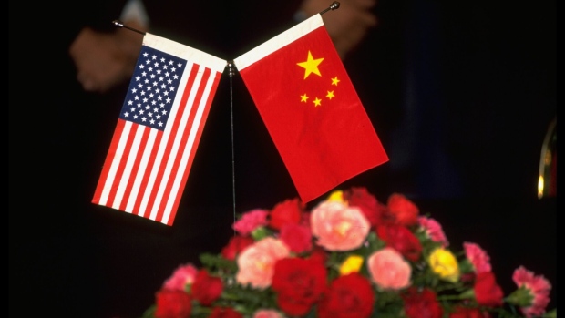 Amer. & Chinese flags table decorations during US/China ceremony renewing 1989 MOA Memo of Agreement re Intl. Trade in Commercial Launch Services.  Photographer: Forrest Anderson/Getty Images