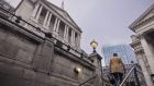 A morning commuter passes the Bank of England (BOE) in the City of London, UK, on Monday, Oct. 17, 2022. The Bank of England said it was restarting its corporate bond-selling as it looks to return to normality in the wake of a sustained selloff in UK assets.