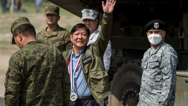 Ferdinand Marcos Jr., Philippines president, center, waves ahead of a live fire exercise as part of the US-Philippines 'Balikatan' joint military exercise at Zambales, the Philippines, on Wednesday, April 26, 2023. The US and the Philippines fired at a decommissioned ship in the South China Sea as part of their largest military drills to date, in a display of defense capabilities amid heightened tensions with Beijing. Photographer: Iya Forbes/Bloomberg
