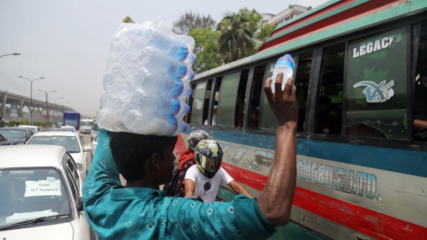 A street vendor sells bottles of chilled water at a traffic signal, in Dhaka, Bangladesh, on June 6.