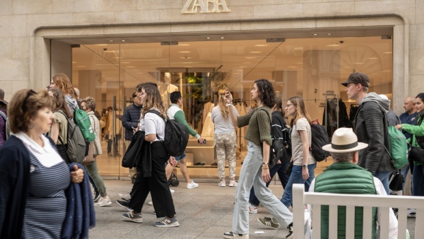 Shoppers pass a Zara clothing store, operated by Inditex SA, in Vigo, Spain, on Wednesday, April 26, 2023. Spain reports GDP figures on Friday.