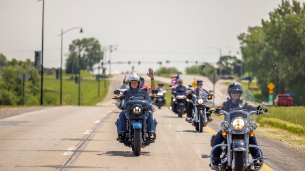 Pence, left, rides a motorcycle during the Roast and Ride hosted by Senator Joni Ernst in Des Moines, Iowa, on June 3.