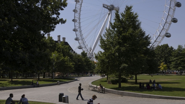 LONDON, UNITED KINGDOM - JULY 19: Members of the public take advantage of the shade near the London Eye on July 19, 2022 in London, United Kingdom. Temperatures were expected to hit 40C in parts of the UK this week, prompting the Met Office to issue its first red extreme heat warning in England, from London and the south-east up to York and Manchester. (Photo by Dan Kitwood/Getty Images)
