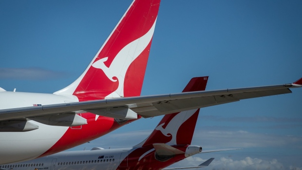 The Qantas Airways Ltd. logo is displayed on the tails of aircraft standing at Brisbane Airport in Brisbane, Australia, on Tuesday, June 9, 2020. Coronavirus-related travel restrictions have put enormous pressure on airlines globally, and none are certain about how the future will pan out as new travel requirements come into force and travelers' attitudes change.