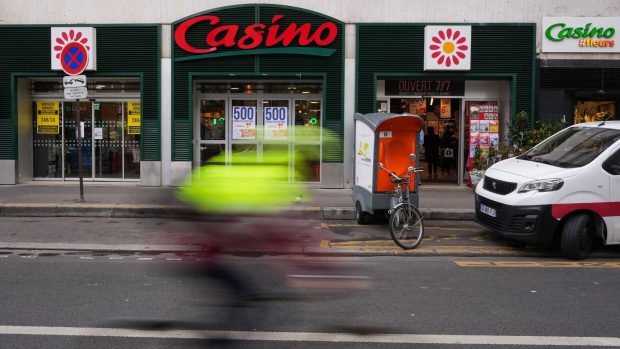 A Casino supermarket, left, and Casino #fleurs florist, operated by Casino Guichard-Perrachon SA, in central Paris, France, on Wednesday, April 12, 2023. The fate of Casino now rests on a deal with Teract SA’s Moez-Alexandre Zouari, who got his start two decades ago running supermarkets under franchises from Jean-Charles Naouri’s company, and whether the two men can pull off a merger of two retail groups.
