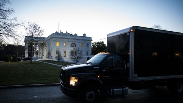 A moving truck departs the West Wing of the White House at dawn on Jan. 20, 2021.