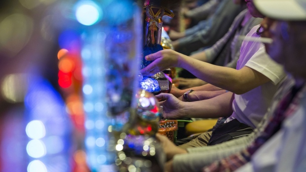 Customers play pachinko machines at a pachinko parlor in Tokyo, Japan, on Tuesday, May 16, 2017. Industry turnover at pachinko parlors has shrunk by a third from a 2005 peak, and the number of venues is in a two-decade decline. Photographer: Shiho Fukada/Bloomberg
