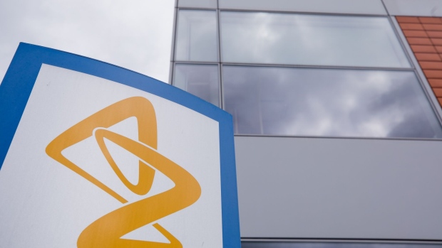 A sign featuring the AstraZeneca Plc logo stands near the company's DaVinci building at the Melbourn Science Park in Cambridge, U.K., on Monday, June 8, 2020. AstraZeneca Plc has made a preliminary approach to rival drugmaker Gilead Sciences Inc. about a potential merger, according to people familiar with the matter, in what would be the biggest health-care deal on record. Photographer: Jason Alden/Bloomberg