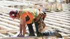 A worker at a residential construction project in Montreal.  Photographer: Graham Hughes/Bloomberg