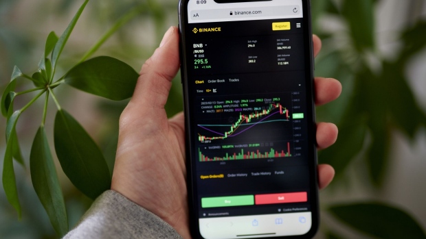 The Binance website on a smartphone arranged in the Brooklyn borough of New York, US, on Tuesday, Feb. 14, 2023. The New York State Department of Financial Services said it had directed Paxos Trust Co. to stop issuing new tokens of crypto's third largest stablecoin, a Binance-branded coin known as BUSD that has roughly $16 billion in circulation.