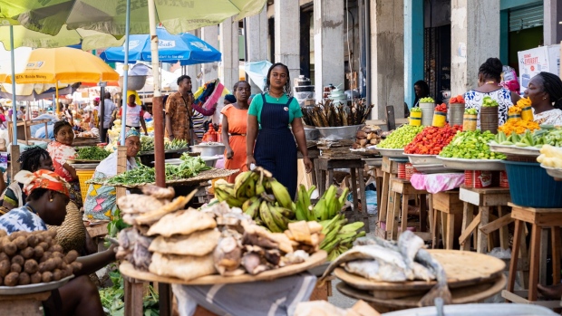 Shoppers walk through a food market in Accra, Ghana, on Tuesday, April 25, 2023. As many as 48 million people across western and central Africa will go hungry in the coming months as efforts to contain inflation contribute to food shortages, the United Nations food agency said.