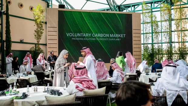 Attendees gather ahead of a voluntary carbon market auction at the Future Investment Initiative (FII) conference in Riyadh, Saudi Arabia, on Tuesday, Oct. 25, 2022. Saudi Arabia hopes the FII will put Riyadh on the map as a global destination for deals, while also improving domestic investment, which has been limited.