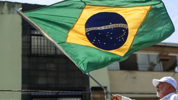 SAO GONCALO, BRAZIL - OCTOBER 20: Brazil's former president and current presidential candidate Luiz Inacio Lula da Silva waves a Brazilian flag during a rally in Sao Gonçalo in the Metropolitan Region on October 20, 2022 in Sao Goncalo, Brazil. (Photo by Buda Mendes/Getty Images)