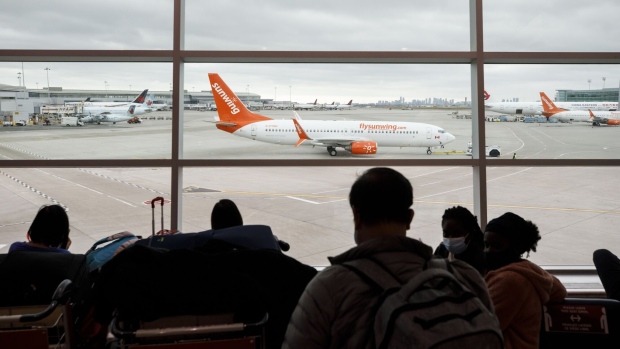 A Sunwing airplane at Toronto Pearson International Airport (YYZ) in Toronto, Ontario, Canada, on Thursday, Dec. 16, 2021. Justin Trudeau's government is asking Canadians to avoid non-essential trips to other countries over the next month as the spread of the omicron Covid-19 variant accelerates.