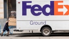 A driver for an independent contractor to FedEx pushes a package into the back of truck in San Francisco, California, U.S., on Monday, June 21, 2021. FedEx Corp. is expected to release earnings figures on June 24. Photographer: David Paul Morris/Bloomberg