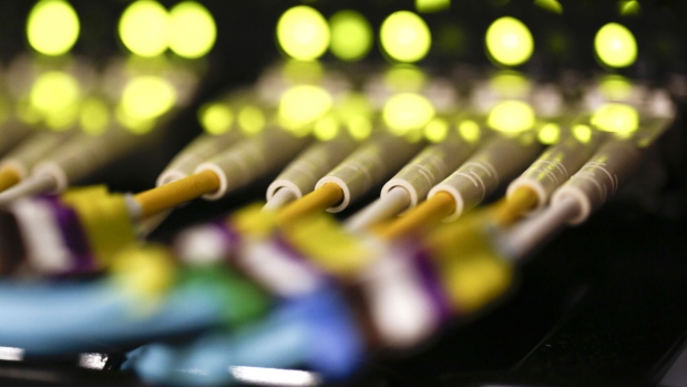 Fibre optic cables feeding into a computer server. Photographer: Simon Dawson