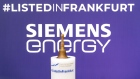 Branding for the Siemens Energy AG listing sits on display behind the opening bell at the Frankfurt Stock Exchange, operated by Deutsche Boerse AG, in Frankfurt, Germany, on Monday, Sept. 28, 2020. Siemens Energy is mulling 300 million euros ($359 million) in additional cost savings over the next three years as the Siemens AG spinoff seeks to improve earnings. Photographer: Thorsten Wagner/Bloomberg