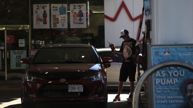 A customer refuels at a Petro-Canada gas station in Toronto, Ontario, Canada, on Friday, July, 29, 2022. A strategic review led by activist investor Elliott Management may lead to a sale of Suncor's retail segment.