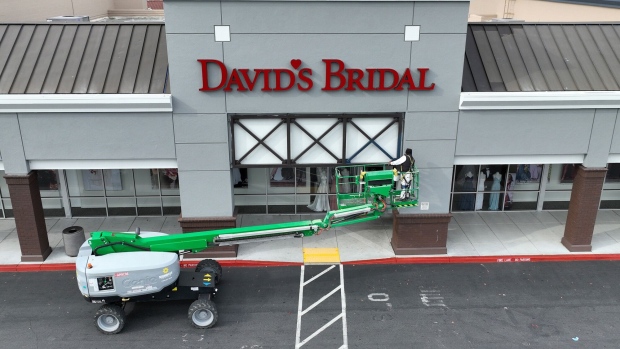 PINOLE, CALIFORNIA - APRIL 17: In an aerial view, a painter is seen working on the exterior of a David's Bridal store on April 17, 2023 in Pinole, California. Wedding retailer David’s Bridal has filed for bankruptcy protection and warned that it is prepared to lay off over 9,000 workers at its 300 stores in the United States. (Photo by Justin Sullivan/Getty Images)