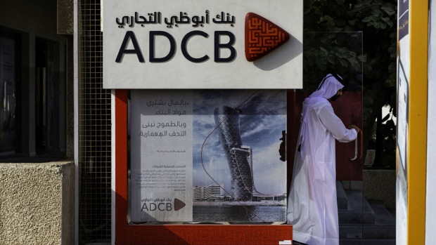 An Emirati man exits after using an Abu Dhabi Commercial Bank PJSC (ADCB) bank automated teller machine (ATM) in Dubai, United Arab Emirates, on Tuesday, Sept. 4, 2018. Abu Dhabi is engineering a second bank merger in its latest attempt to stay competitive in the era of lower oil prices.