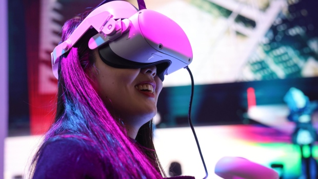 An attendee wears a Meta Platforms Inc. Oculus Quest 2 virtual reality (VR) headset on day two of the Mobile World Congress at the Fira de Barcelona venue in Barcelona, Spain, on Tuesday, Feb. 28, 2023. The annual flagship mobile industry and technology event runs from Feb. 27 to March 2.