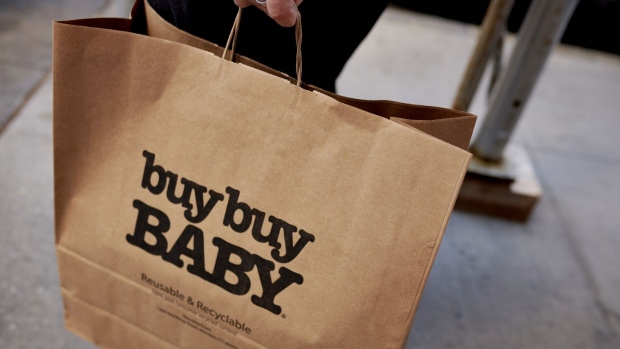 A customer carries a Buy Buy Baby shopping bag in New York, US, on Thursday, Aug. 25, 2022. Bed Bath & Beyond Inc. is looking to mortgage its prized Buybuy Baby brand in its urgent effort to raise financing as sales slump, cash runs low and unpaid vendors withhold shipments. Photographer: Gabby Jones/Bloomberg