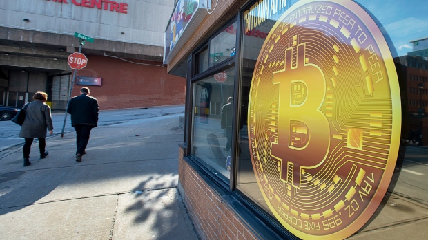 A sign advertises a Bitcoin automated teller machine