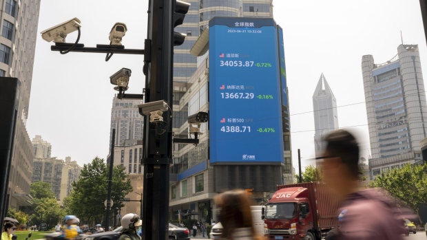 A public screen displaying stock figures in Pudong's Lujiazui Financial District n Shanghai, China, on Wednesday, June 21, 2023. China's yuan weakened past the closely watched 7.2-per-dollar level as investor sentiment soured on a lack of aggressive stimulus and Beijing signaled a level of comfort about the declines. Photographer: Raul Ariano/Bloomberg
