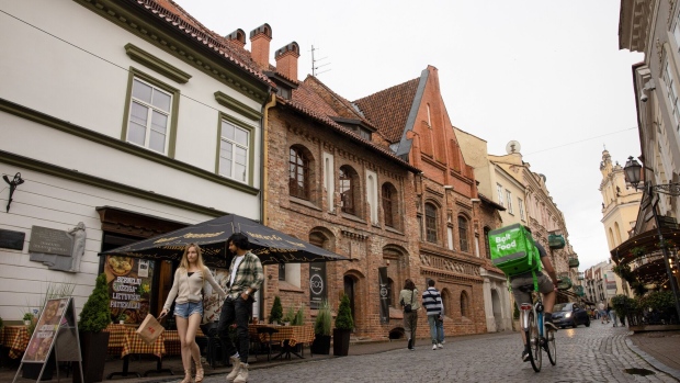 Shoppers walk along a cobbled street in the old town in Vilnius, Lithuania, on Saturday, June 25, 2023. Germany’s defense chief said the country is prepared to station a permanent brigade of some 4,000 troops in Lithuania to help shore up NATO’s eastern flank against potential Russian aggression. Photographer: Andrey Rudakov/Bloomberg