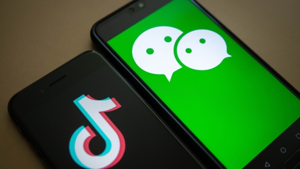The logo for Tencent Holdings Ltd.'s WeChat app, right, and the logo for ByteDance Ltd.'s TikTok app are arranged for a photograph on smartphones in Hong Kong, China, on Friday, Aug. 7, 2020. President Donald Trump signed a pair of executive orders prohibiting U.S. residents from doing business with the Chinese-owned TikTok and WeChat apps beginning 45 days from now, citing the national security risk of leaving Americans' personal data exposed. Photographer: Ivan Abreu/Bloomberg