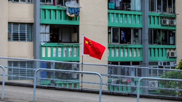 A Chinese flag flies at a public housing estate to mark the 25th anniversary of Hong Kong's return to Chinese rule in Hong Kong, China, on Wednesday, June 22, 2022. The rising number of Covid cases in Hong Kong has caused some unease before the July 1 handover anniversary marking 25 years since Britain returned the city to Chinese control. Photographer: Paul Yeung/Bloomberg