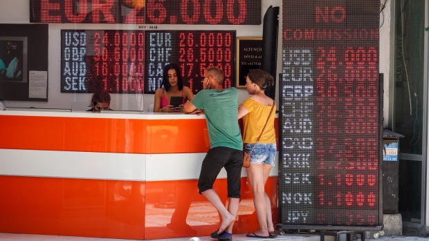 Tourists at a currency exchange bureau in Bodrum, Turkey, on Thursday, July 6, 2023. The lira has lost 28% of its value so far this year, the biggest decline among 31 major currencies tracked by Bloomberg, after the Argentine peso. Photographer: Moe Zoyari/Bloomberg
