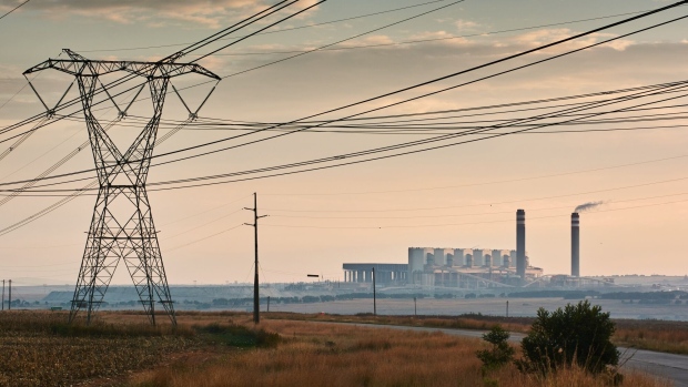 The Eskom Holdings SOC Ltd. Kusile coal-fired power station beyond a high voltage electricity transmission tower in Mpumalanga, South Africa, on Friday, May 5, 2023. Debt-strapped Eskom is currently implementing daily blackouts because its dilapidated power plants are unable to supply enough electricity to meet demand and it doesn’t have the money to invest in capital equipment.