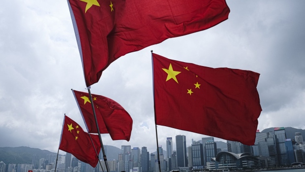 HONG KONG, CHINA - OCTOBER 01: People wave with a flag of China to celebrate China National Day on October 1, 2022 in Hong Kong, China. China celebrates its National Day on October 1st 2022, marking the 73rd founding anniversary of the People's Republic of China. (Photo by Keith Tsuji/Getty Images)