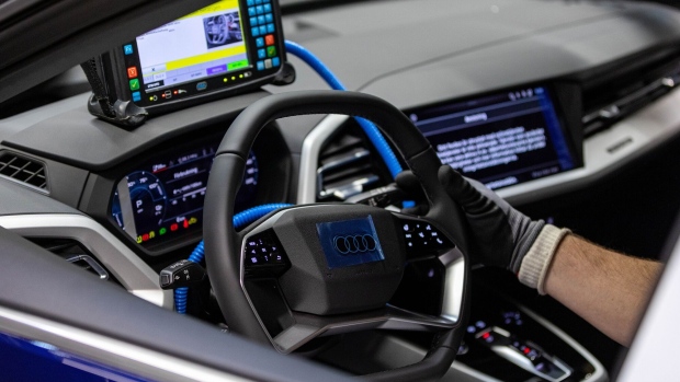 An employee runs a diagnostic test on an Audi Q4 e-tron electric vehicle (EV) on the assembly line at the Volkswagen AG (VW) electric automobile plant in Zwickau, Germany, on Tuesday, April 26, 2022. The Zwickau assembly lines are the centerpiece of a plan by VW, the world's biggest automaker, to manufacture as many as 330,000 cars annually.