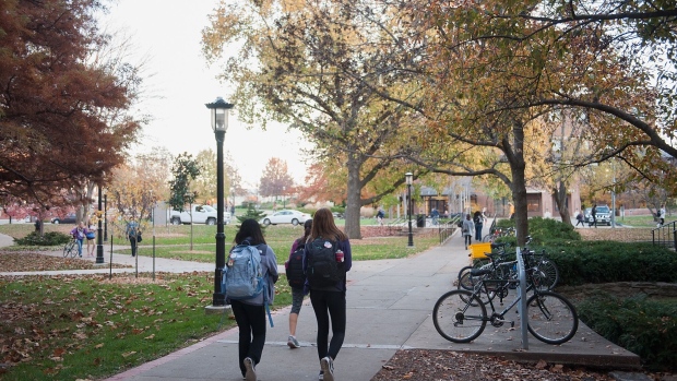 Students walk along on a university campus.