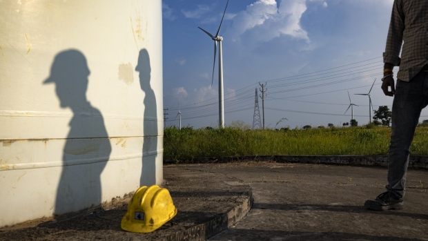 Workers from EKI Energy Services Ltd. at a ReGen Powertech Pvt. wind farm in Dewas, Madhya Pradesh, India, on Friday, Sept. 9, 2022. Prime Minister Narendra Modi is pushing a 2070 net-zero goal, and his Power Minister, Raj Kumar Singh, has said the country will limit exports of credits to prioritize its own climate goals. Photographer: Aparna Jayakumar/Bloomberg