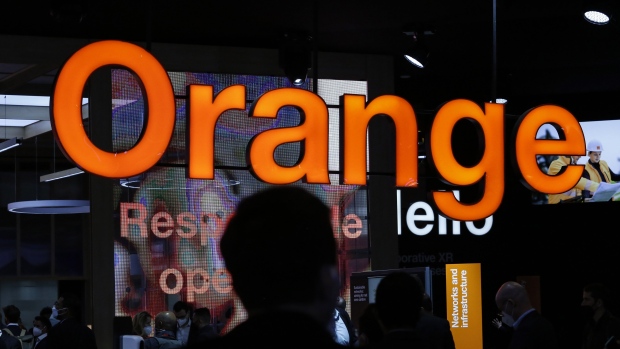 An illuminated logo on the Orange SA stand on the opening day of the MWC Barcelona at the Fira de Barcelona venue in Barcelona, Spain, on Monday, Feb. 28, 2022. Over 1,800 exhibitors and attendees from 183 countries will attend the annual event, which runs from Feb. 28 to March 3. Photographer: Angel Garcia/Bloomberg