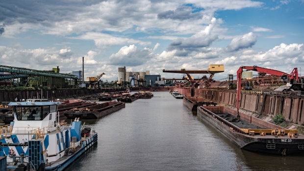 Ships being unloaded at a harbour at the Thyssenkrupp steel plant in Duisburg, in Germany, on Thursday, July 20, 2023.