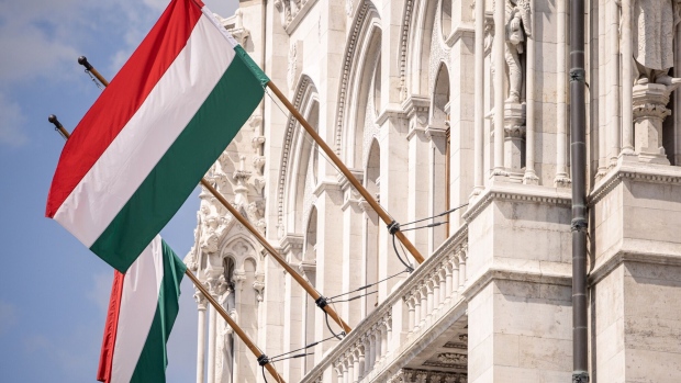 National flags outside the Hungarian Parliament building in Budapest, Hungary, on Wednesday, April 19, 2023. Hungary Prime Minister Viktor Orban has been the target of fierce criticism from its European Union and NATO allies for maintaining close ties with Russia since President Vladimir Putin invaded Ukraine.