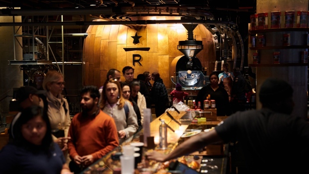 Customers wait in line inside a Starbucks Reserve Roastery in the Meatpacking District of New York, US, on Monday, May 1, 2023. Starbucks Corp. is scheduled to release earnings figures on May 2. Photographer: Bing Guan/Bloomberg