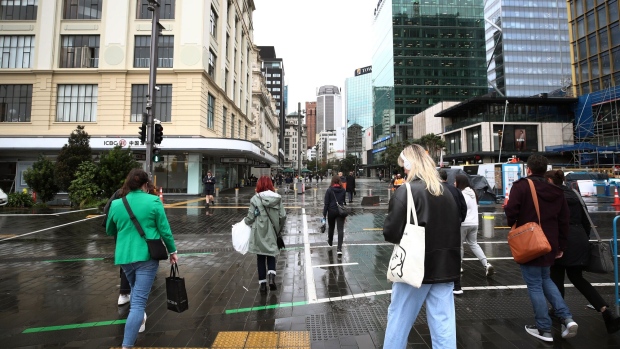 Pedestrians cross a road in Auckland, New Zealand, on Monday, May 22, 2023. New Zealand is scheduled to release consumer confidence figures on May 26. Photographer: Fiona Goodall/Bloomberg