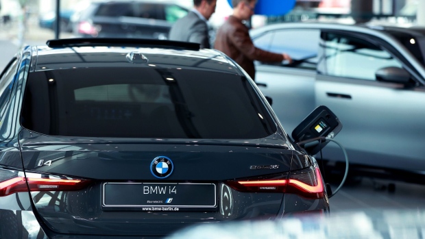 A BMW i4 electric vehicle (EV) on display at a BMW AG showroom in Berlin, Germany, on Tuesday, March 14, 2023. Risks for the carmaker’s 2023 outlook are mounting as consumer confidence is eroding and rising interest rates may impact sales once pent-up demand is exhausted. Photographer: Krisztian Bocsi/Bloomberg