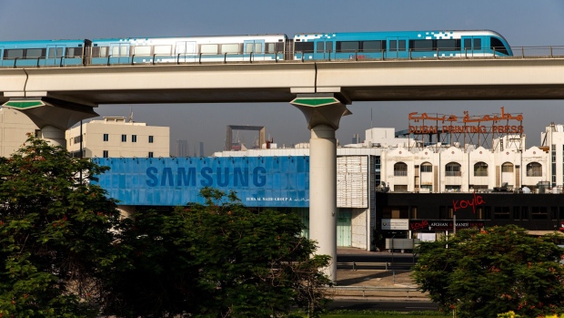 A Roads and Transport Authority (RTA) metro train passes a vacant Samsung Electronics Co. store, operated by Juma Al Majid Group, in Dubai, United Arab Emirates, on Tuesday, June 9, 2020. “An exodus of middle class residents could create a death spiral for the economy,” said Ryan Bohl, a Middle East analyst at Stratfor.” Photographer: Christopher Pike/Bloomberg