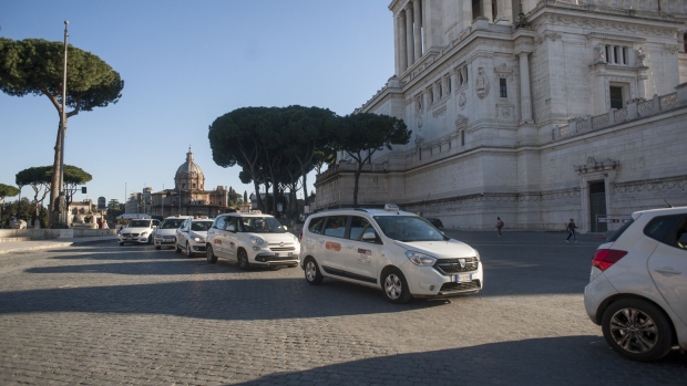 Taxis wait for customers along the Roman Forum near Piazza Venezia in Rome, Italy, on Wednesday, March 11, 2020. Italian Prime Minister Giuseppe Conte’s government is ready to spend as much as 25 billion euros ($28.3 billion) on stimulus measures to shield the economy from Europe's worst outbreak of the coronavirus.